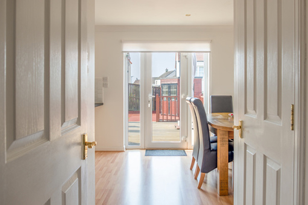 View through the open door of an apartment with glass patio doors